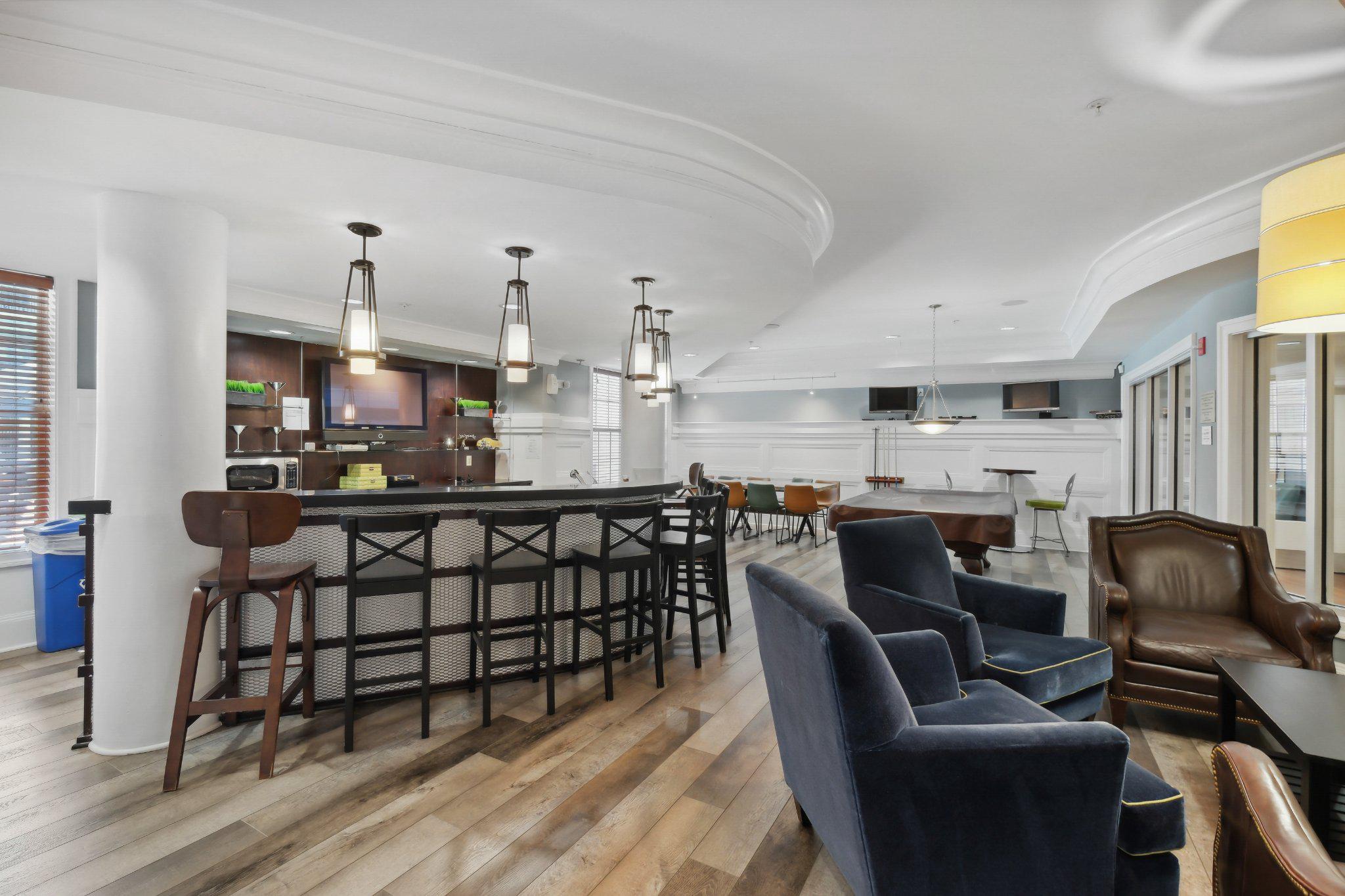 31 Booth Street, Unit B55 Gaithersburg, MD 20878 - Photo 28 of 30 a kitchen with stainless steel appliances kitchen island granite countertop a dining table chairs and a refrigerator