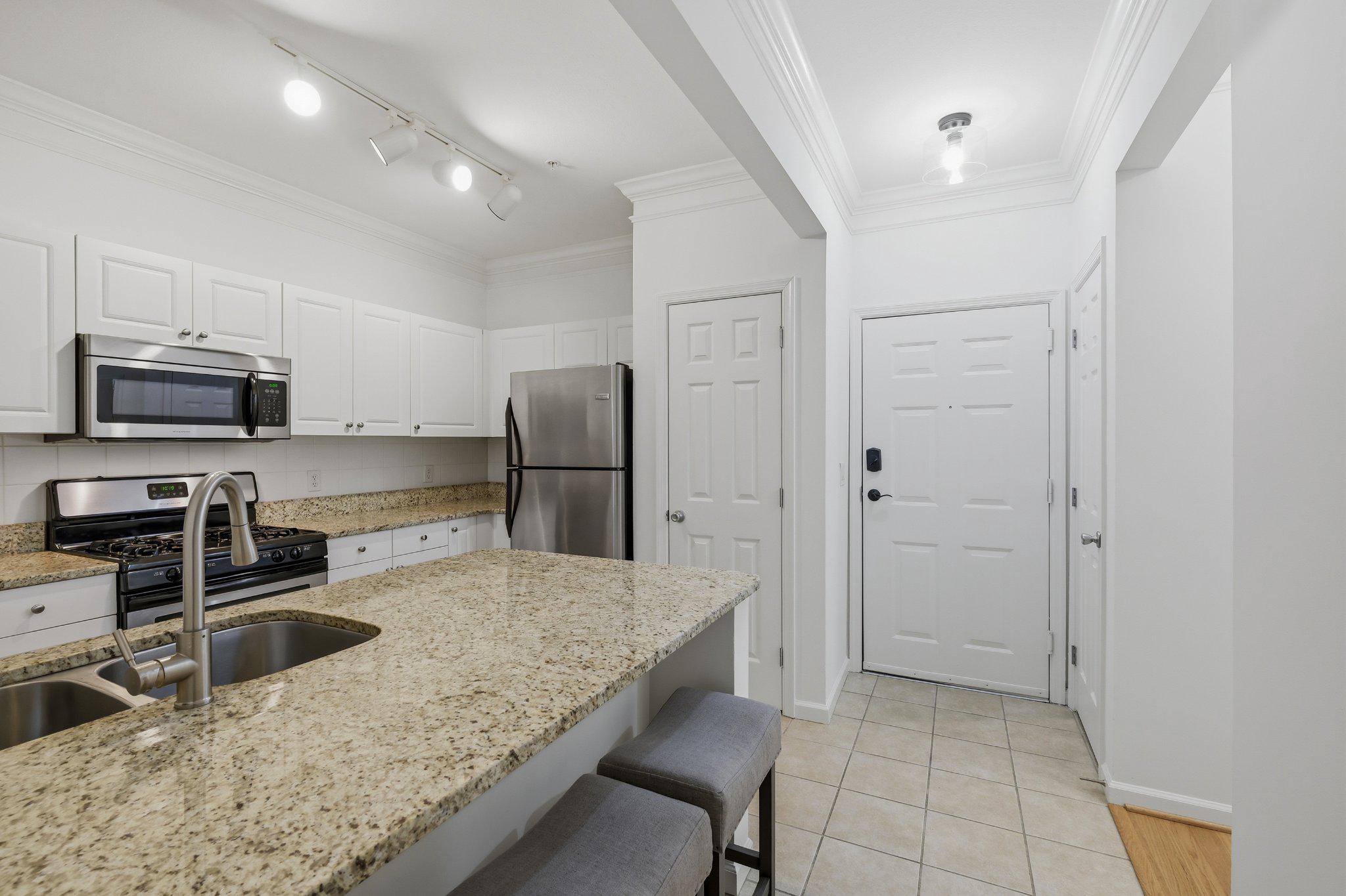31 Booth Street, Unit B55 Gaithersburg, MD 20878 - Photo 5 of 30 a kitchen with stainless steel appliances granite countertop a refrigerator and a stove top oven