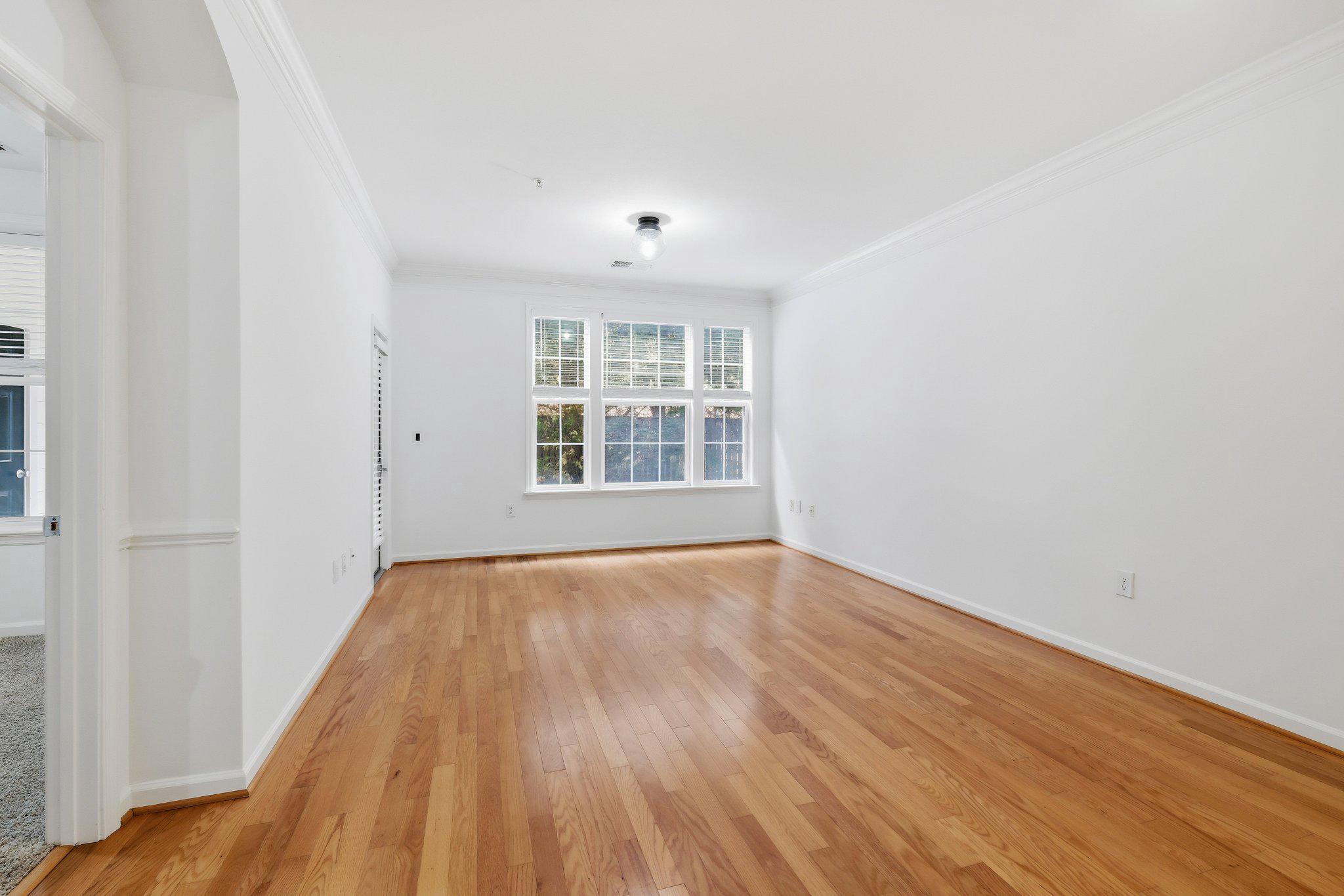 31 Booth Street, Unit B55 Gaithersburg, MD 20878 - Photo 8 of 30 wooden floor in an empty room with a window
