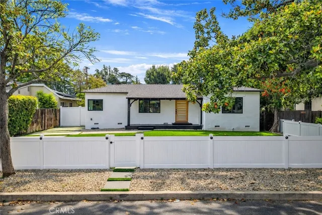 a front view of house with yard and trees