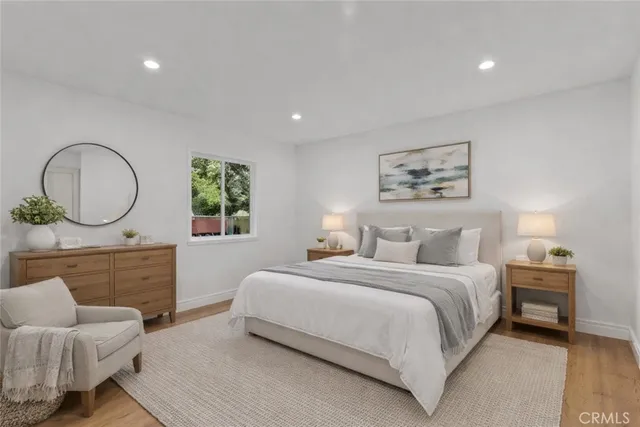 a bedroom with a large bed and a chandelier