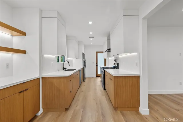 a view of kitchen and kitchen with stainless steel appliances