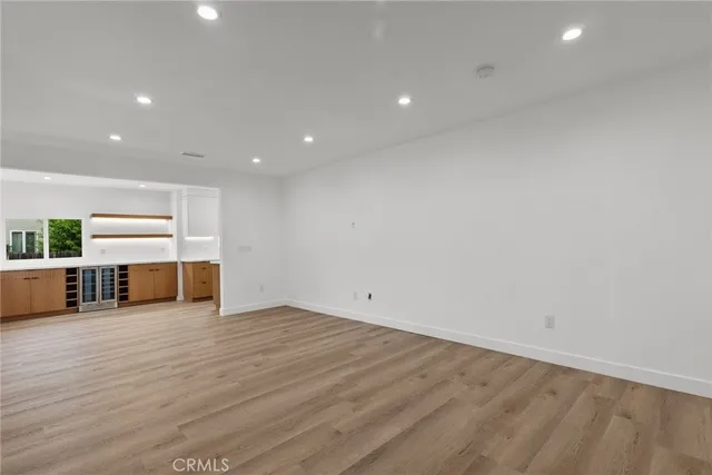 a view of a kitchen with a fridge and window