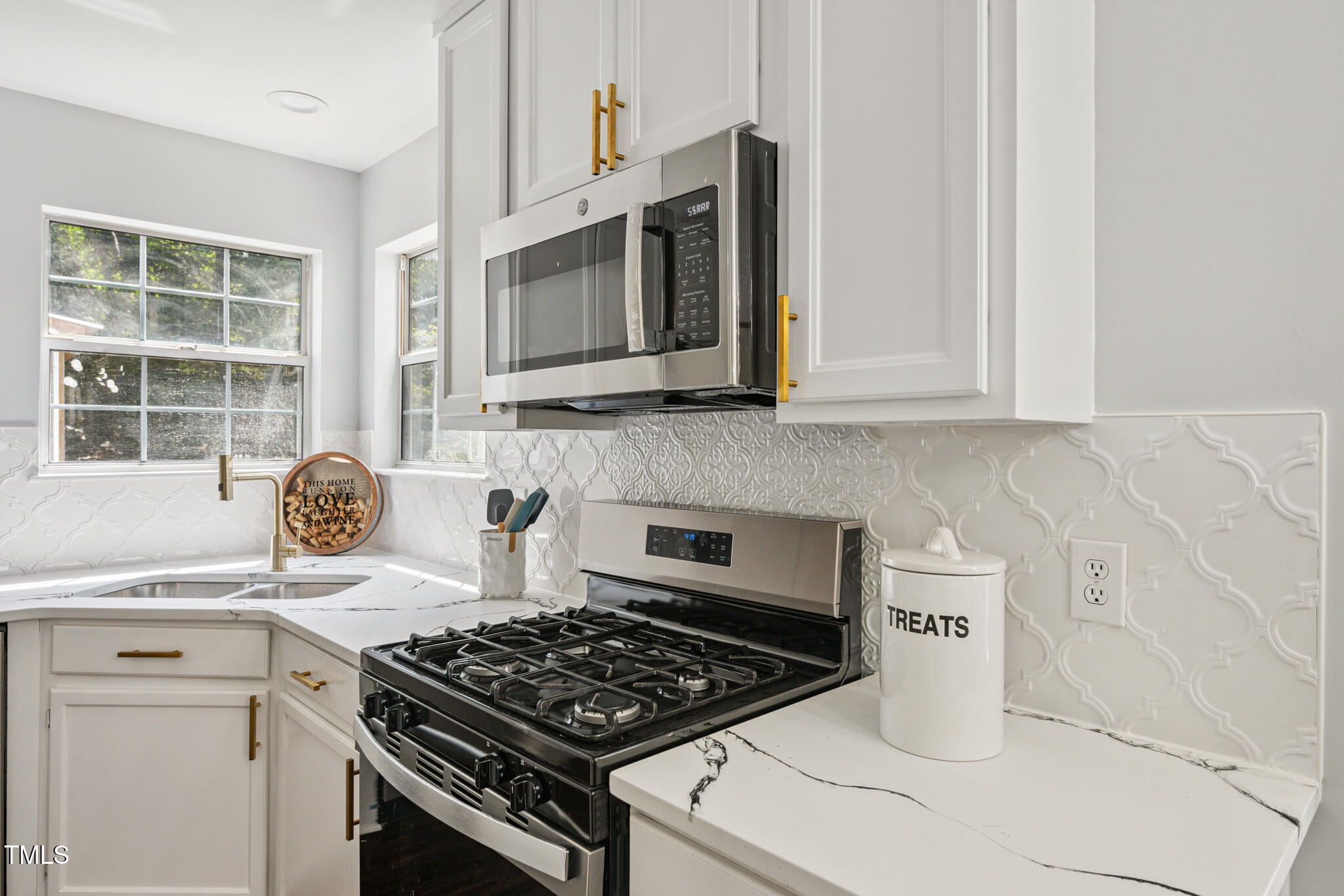 2516 Constitution Drive Raleigh, NC 27615 - Photo 11 of 38 a kitchen with granite countertop a stove and a sink
