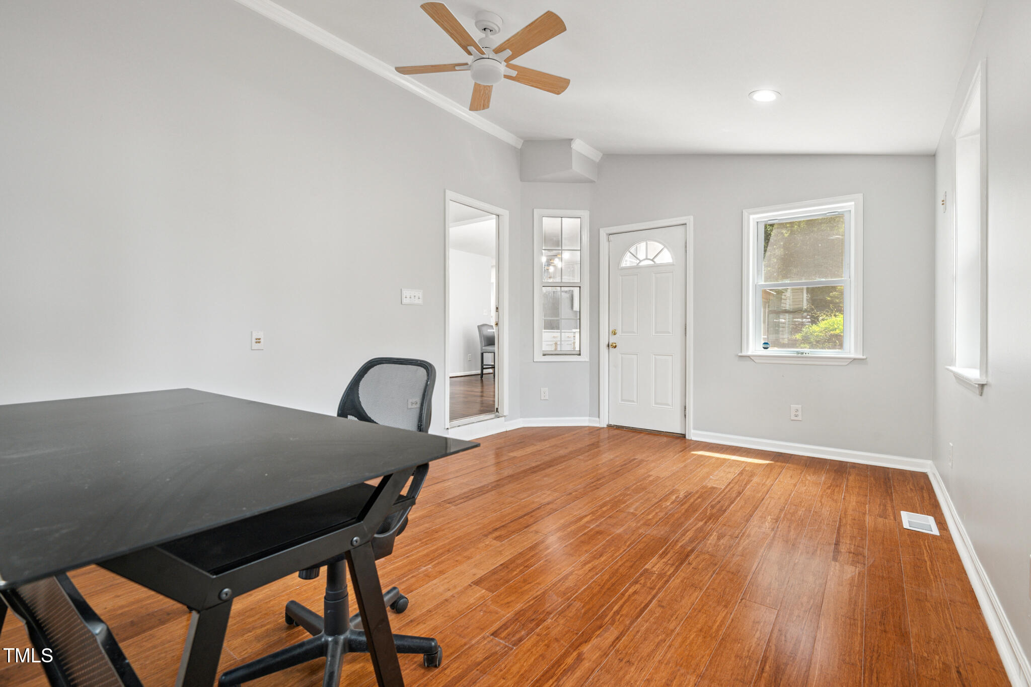 2516 Constitution Drive Raleigh, NC 27615 - Photo 21 of 38 a bedroom with a bed and a table with wooden floor