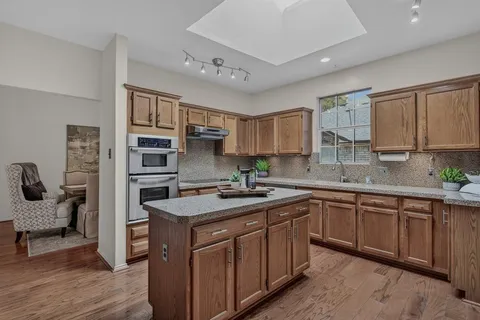 a kitchen with stainless steel appliances granite countertop a sink and cabinets
