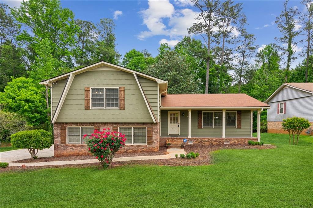 3240 Corktree Trail Stonecrest, GA 30038 - Photo 1 of 1 a front view of a house with a garden and porch