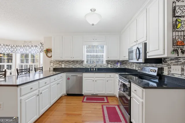 a kitchen with sink cabinets and wooden floor