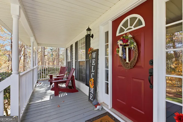 a view of entryway with a rug wooden floor and a chandelier