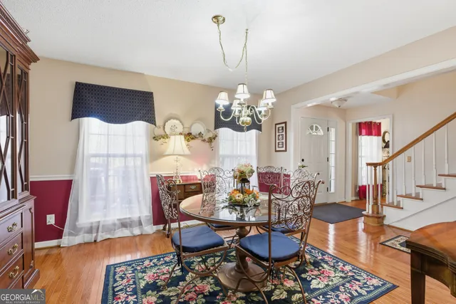 a living room with furniture a piano and a bookshelf