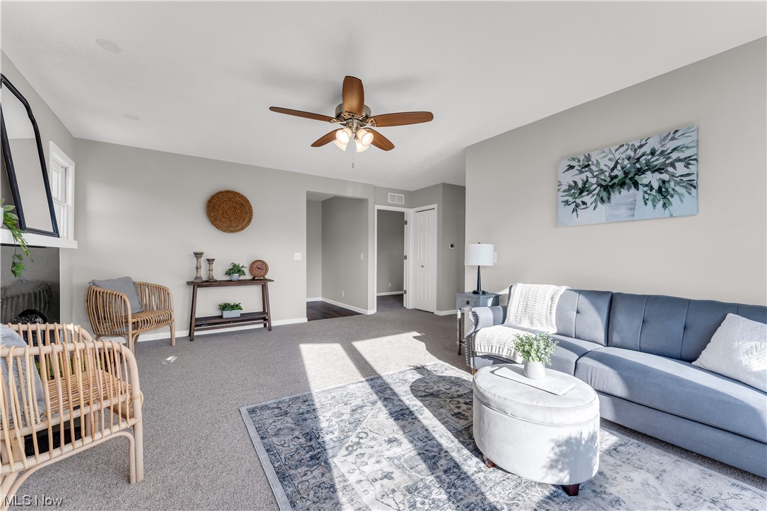 7501 Southland Road Mentor, OH 44060 - Photo 7 of 21 Carpeted living room featuring ceiling fan