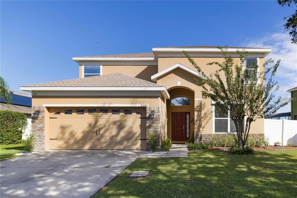 3680 Ricky Lane St. Cloud, FL 34772 - Photo 1 of 1 a front view of a house with a garden