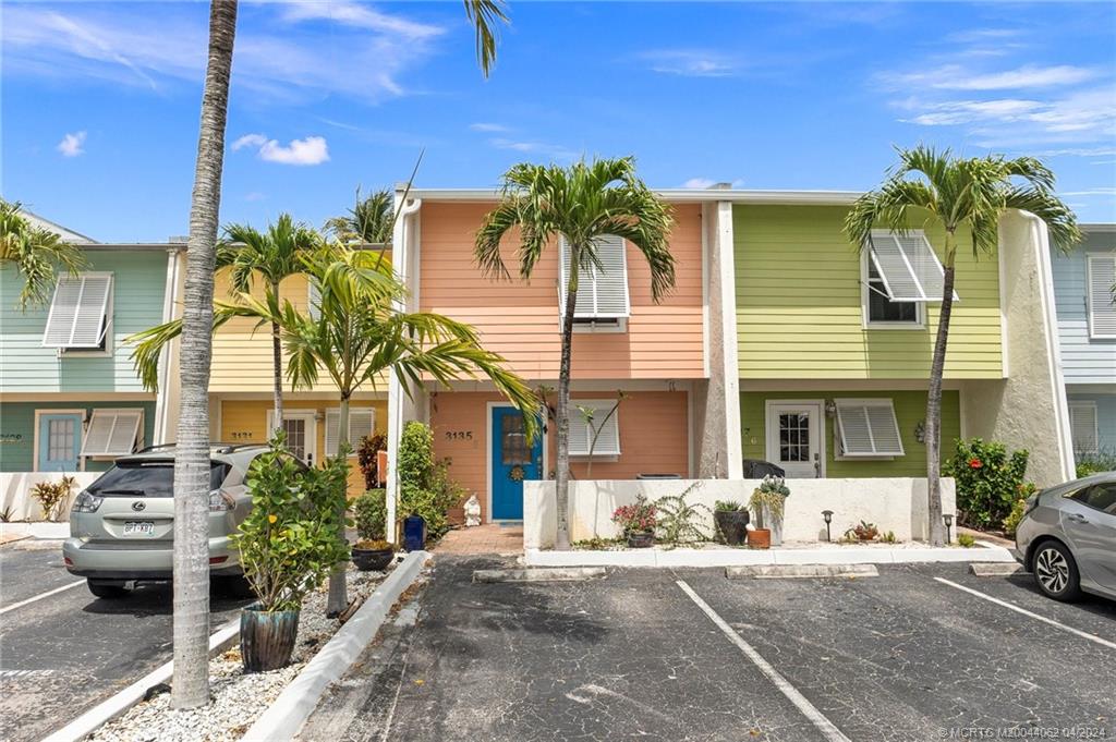 3135 Southeast Indian Street, Unit 5 Stuart, FL 34997 - Photo 1 of 41 a front view of a house with garden