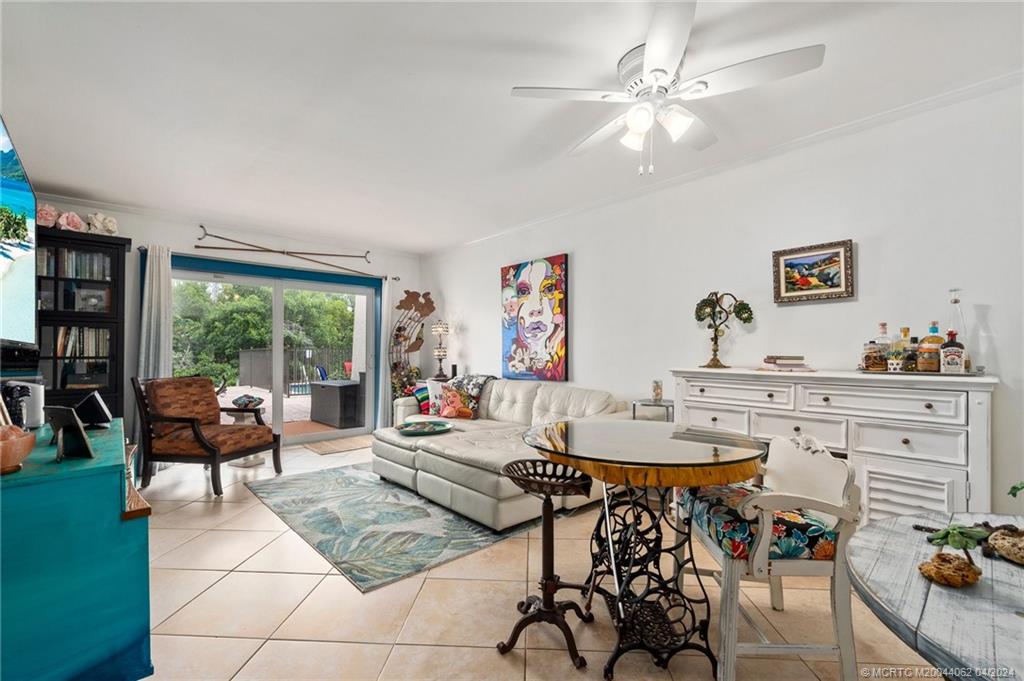 3135 Southeast Indian Street, Unit 5 Stuart, FL 34997 - Photo 13 of 41 a living room with furniture and a large window