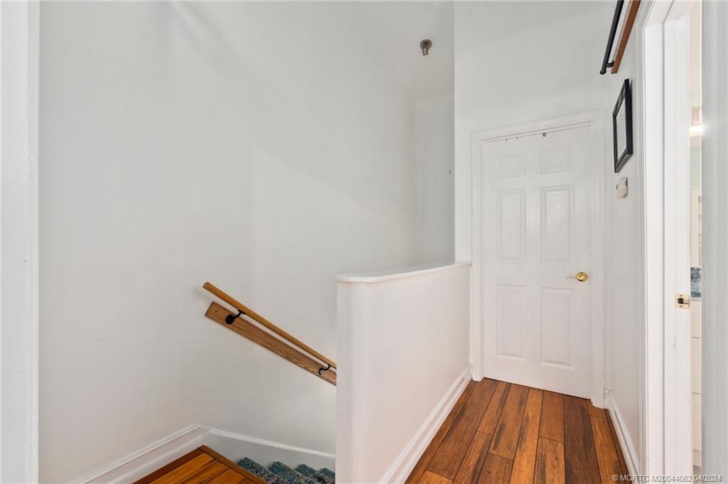 3135 Southeast Indian Street, Unit 5 Stuart, FL 34997 - Photo 19 of 41 a view of a hallway with wooden floor