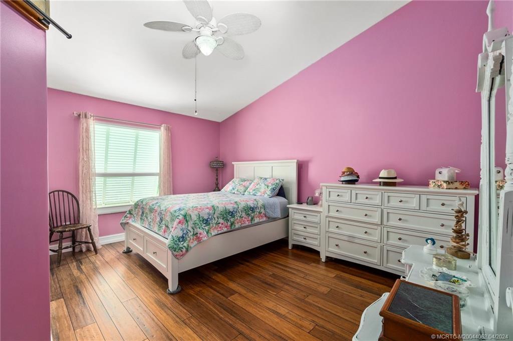 3135 Southeast Indian Street, Unit 5 Stuart, FL 34997 - Photo 21 of 41 a bedroom with a bed and a window