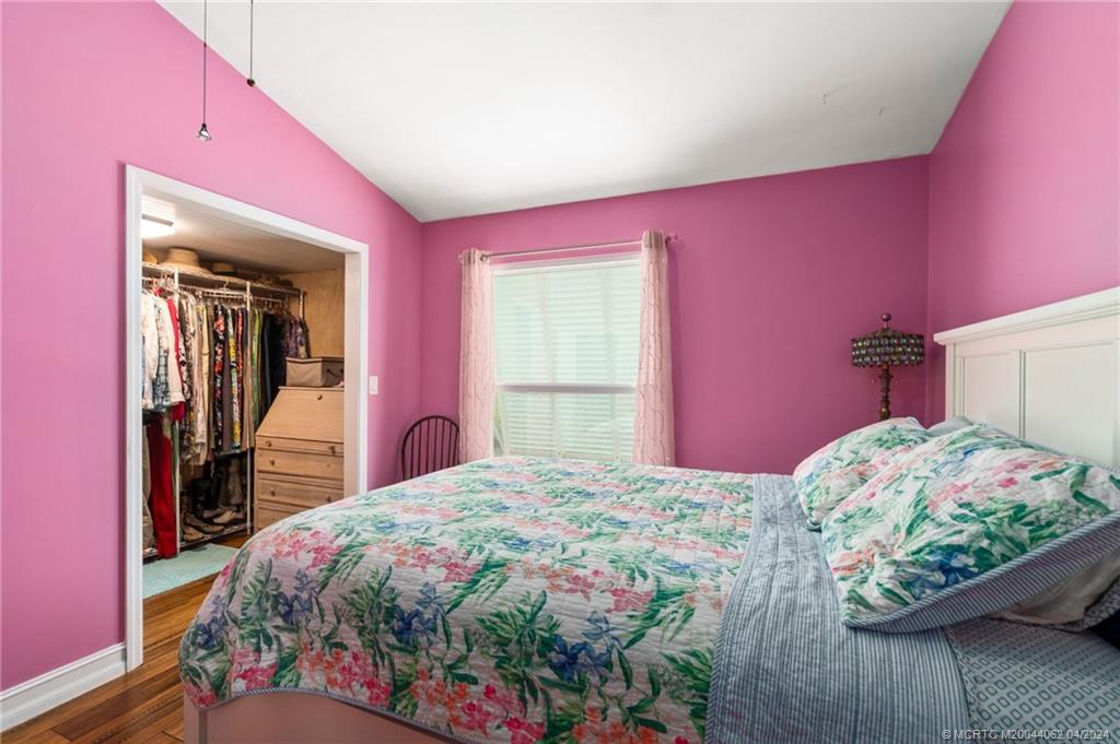 3135 Southeast Indian Street, Unit 5 Stuart, FL 34997 - Photo 22 of 41 a bedroom with a bed and a dresser