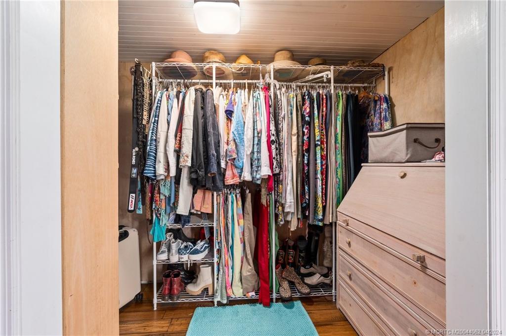 3135 Southeast Indian Street, Unit 5 Stuart, FL 34997 - Photo 23 of 41 a view of walk in closet with clothes and shoes