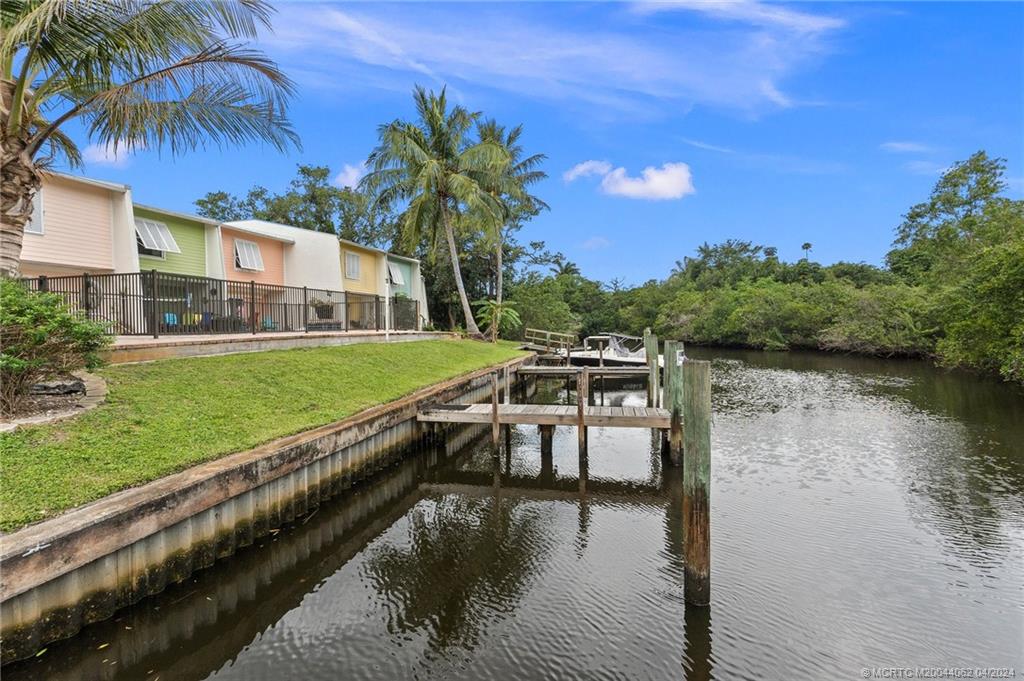 3135 Southeast Indian Street, Unit 5 Stuart, FL 34997 - Photo 3 of 41 a view of a house with pool and a yard