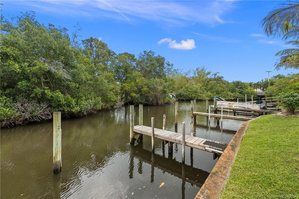 3135 Southeast Indian Street, Unit 5 Stuart, FL 34997 - Photo 39 of 41 a view of a lake with a deck