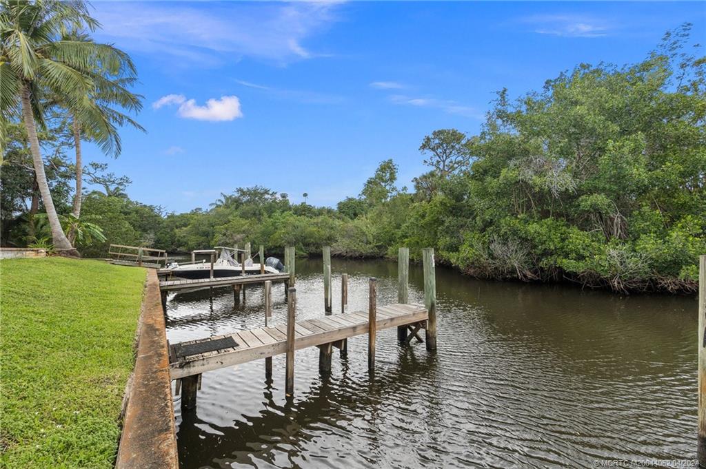3135 Southeast Indian Street, Unit 5 Stuart, FL 34997 - Photo 40 of 41 a view of a lake with sitting area