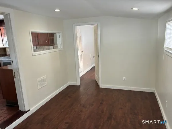 an empty room with wooden floor