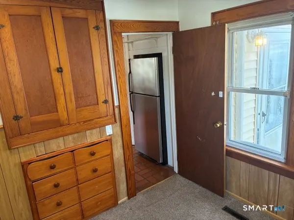 an empty room with wooden floor and closet
