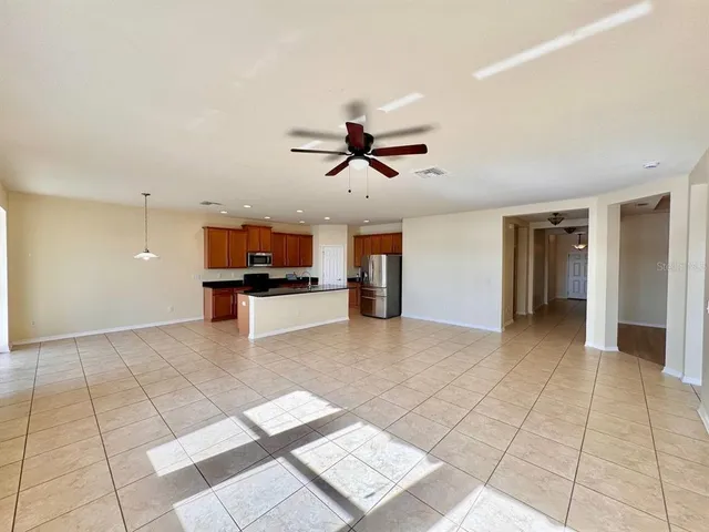 a view of workspace with furniture and ceiling fan