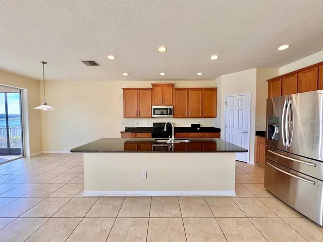 a kitchen with stainless steel appliances a refrigerator sink and microwave