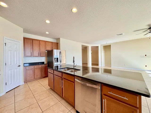 a kitchen with stainless steel appliances granite countertop a sink and cabinets