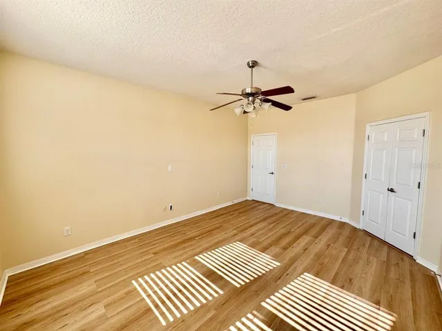 a view of a room with wooden floor and closet