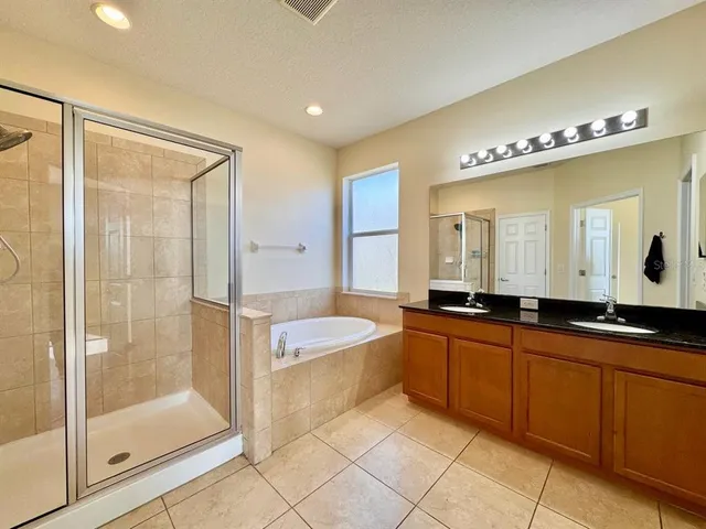 a large bathroom with a glass shower door