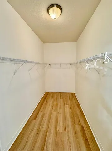 a view of a room with wooden floor