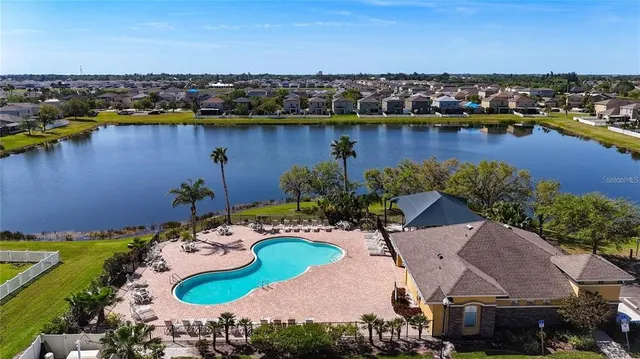 an aerial view of a house with a lake view