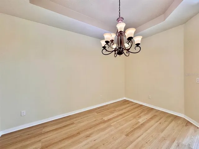 a view of a room with wooden floor fan and window