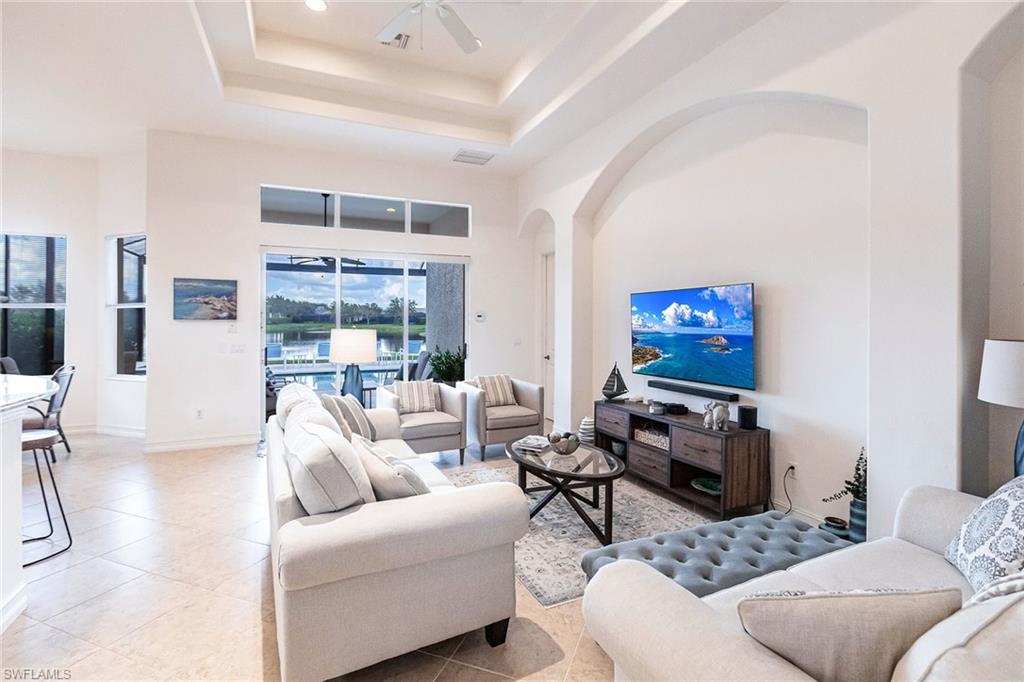 7863 Valencia Court Naples, FL 34113 - Photo 11 of 50 a living room with furniture and a flat screen tv