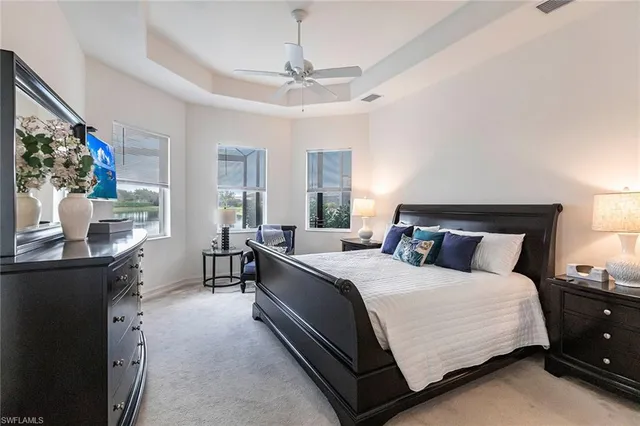 a bedroom with a bed and dresser with window