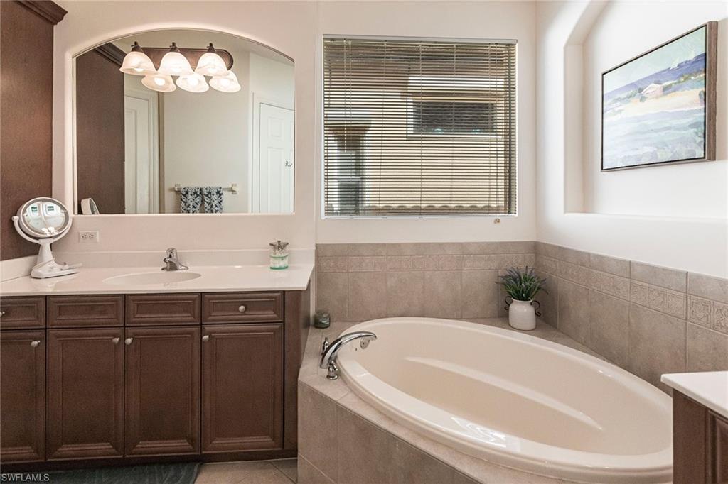 7863 Valencia Court Naples, FL 34113 - Photo 28 of 50 a bathroom with a sink and a bathtub