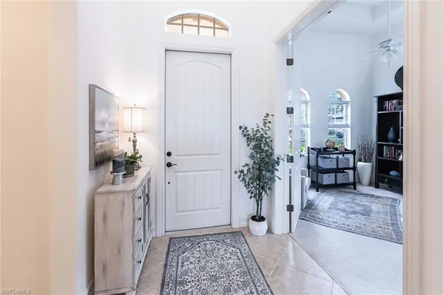 a view of a hallway and a livingroom with furniture