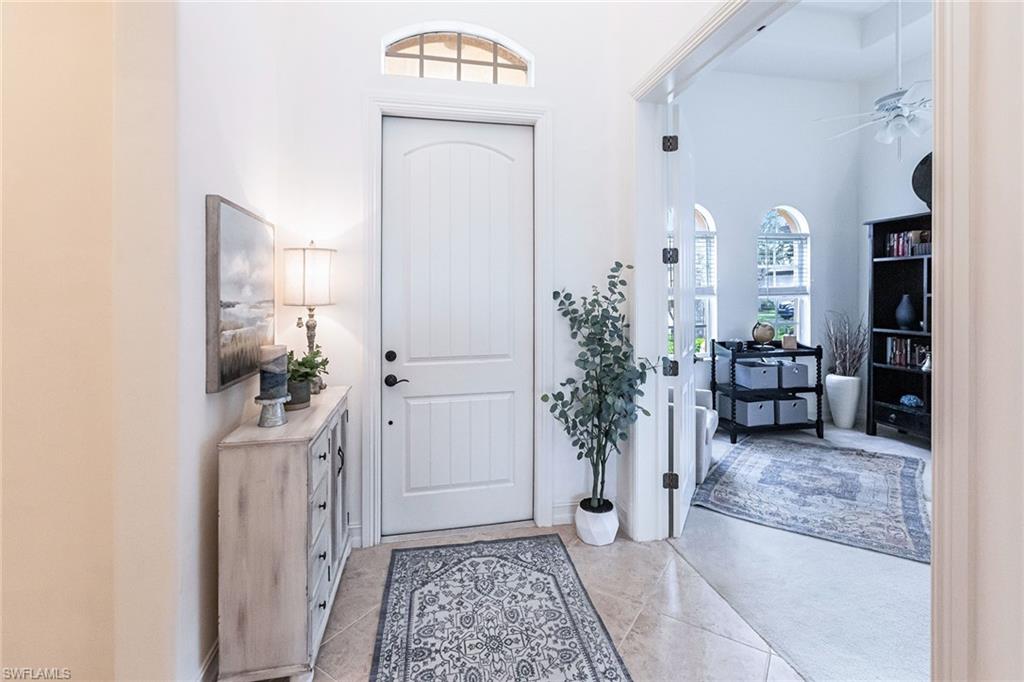 7863 Valencia Court Naples, FL 34113 - Photo 4 of 50 a view of a hallway and a livingroom with furniture
