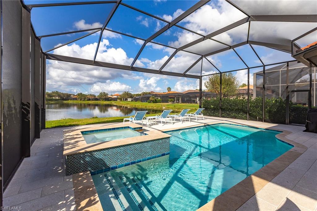 7863 Valencia Court Naples, FL 34113 - Photo 44 of 50 a view of a patio with a table and chairs under an umbrella