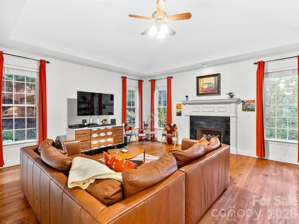 a living room with furniture fireplace and flat screen tv