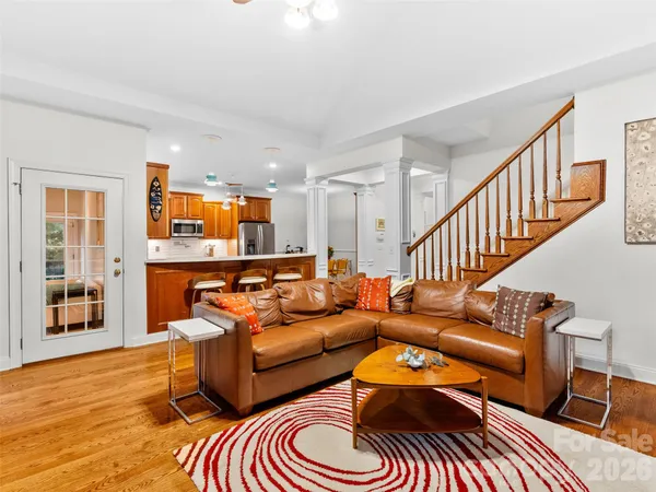 a living room with furniture and a wooden floor