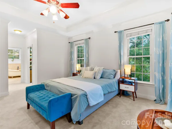 a bedroom with a bed couch and a window