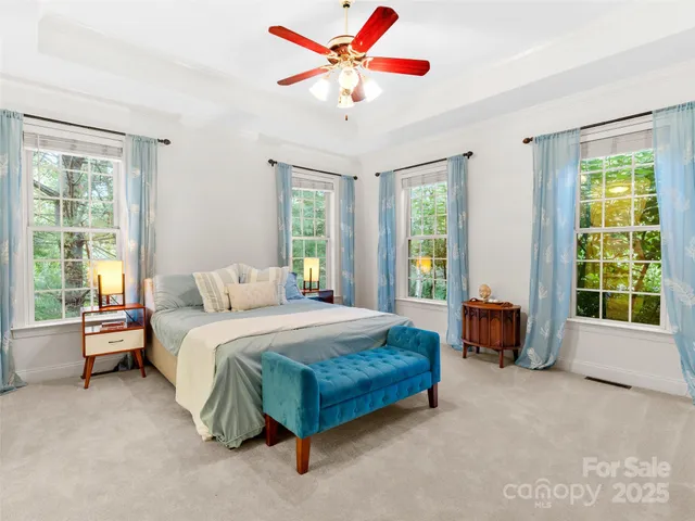 a spacious bedroom with a bed and a large window