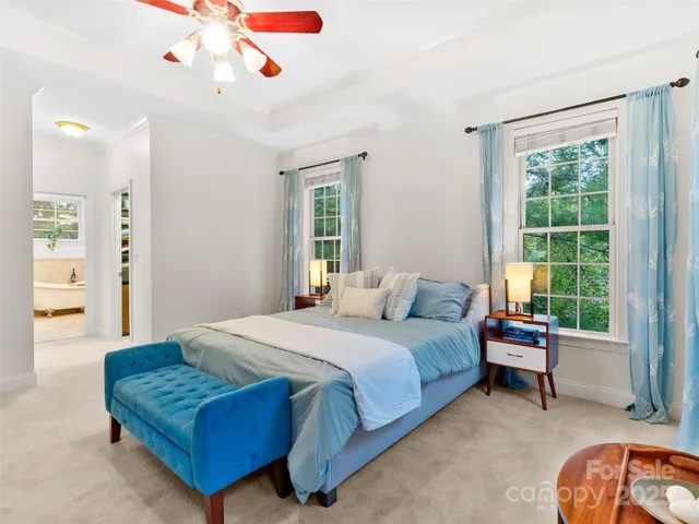 a bedroom with a bed couch and a window