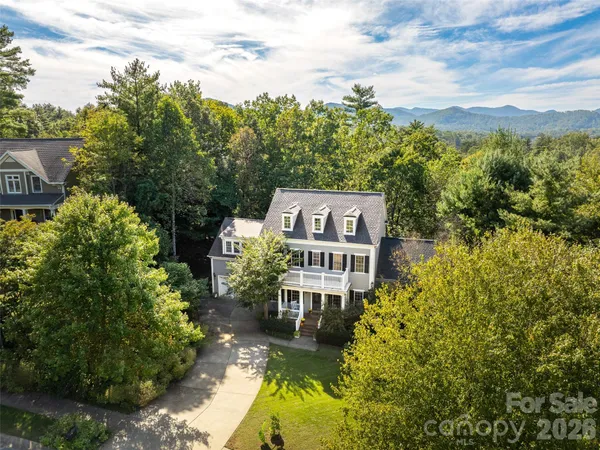 a view of a house with a yard and potted plants