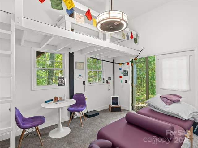 a view of a house with a yard and potted plants