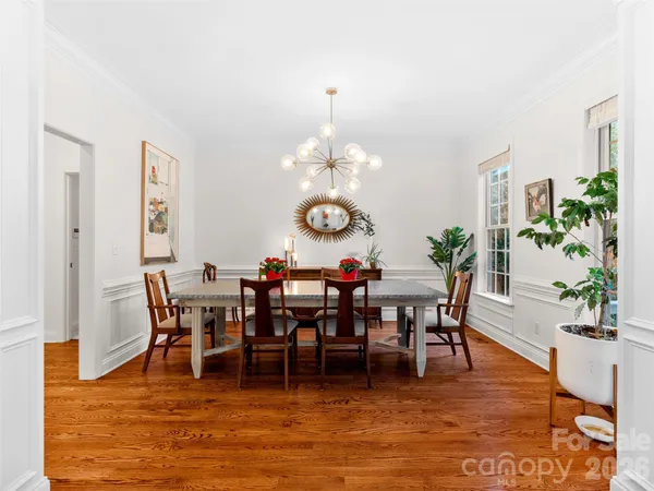 a view of a dining room with furniture and chandelier