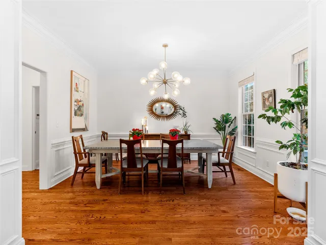 a view of a dining room with furniture and chandelier